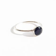 A B O U T : A delicate ring sterling silver with a circle solitaire natural black onyx gemstone cabochon cut.  Gold option available. M E A S U R E M E N T S : Stone 6mm wide. Band 1.2mm thick M A T E R I A L S : Solid sterling silver. Natural black onyx. All materials sourced locally. M E A N I N G : Black Onyx is a popular and powerful gemstone. The keywords behind Black Onyx meaning are: intuition, rejuvenation, divination, strength, change, balance, grounding, focus, self-confidence, banishi Minimalist Ring With Polished Round Stone, Minimalist Rings With Polished Round Stone, Minimalist Jewelry With Polished Round Stone, Black Birthstone Rings, Everyday Round Onyx Jewelry, Everyday Sterling Silver Cabochon Jewelry, Minimalist Onyx Gemstone Ring, Minimalist Oval Cabochon Jewelry, Everyday Black Sterling Silver Jewelry