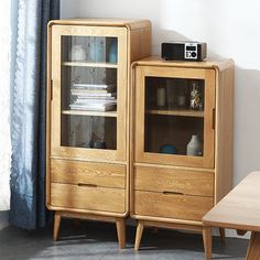 a wooden cabinet sitting next to a table