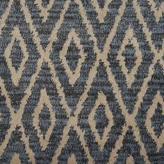 an area rug with blue and beige designs on it