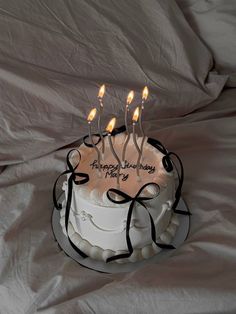 a birthday cake with lit candles on it