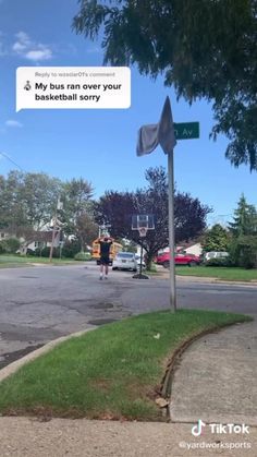 a man walking across a street next to a basketball hoop with a sign on it