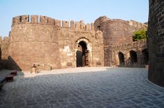 an old castle with stone walls and arches