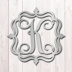 the letter k is cut out from paper and placed on a wooden background with an arrow