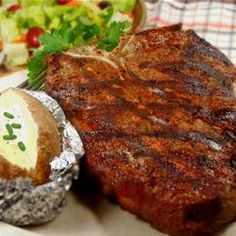 steak, potatoes and salad are on the table