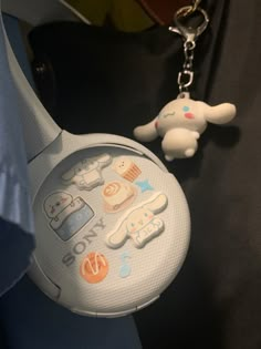 a keychain with an animal shaped object attached to it's back end