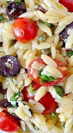 pasta salad with cherry tomatoes, olives and parmesan cheese