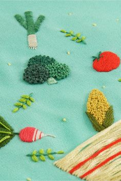 a close up of a piece of cloth with different types of fruits and vegetables on it