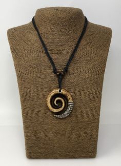 "*Beautiful Spiral Necklace *The Spiral signifies a New Beginning, Spirituality, Peace and Tranquility *Adjustable Black Cord - Fits Most Size - From 16\" Inches up to to 30\" Inches. Pull the knots and the cord to adjust the lenght *Pendant Dimensions: Approximately 2\" Inches x 2\" inches This beautiful necklace is simply stunning. Our commitment to excellent quality ensures each piece is skillfully inspected. Order this today or browse our incredible selection of jewelry. FAST SHIPPING! *Firs Adjustable Symbolic Spiral Jewelry, Symbolic Adjustable Spiral Jewelry, Brown Spiral Necklace For Gifts, White Cocoa, Spiral Symbol, Rasta Earrings, Eye Of Horus Necklace, Spiral Jewelry, Spiral Pendant