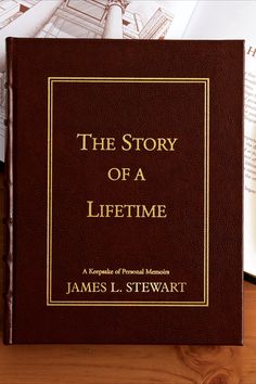 the story of a lifetime by james l stewart on a table next to an open book