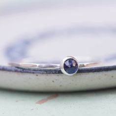 Tiny skinny stackable ring with beautiful deep blue Sapphire stone. It is made with a skinny but sturdy band, which allows you to create beautiful stacking sets! The ring is ideal for everyday wear and it will also look amazing with a festive dress. The ring is 0,8-0,9 mm thick and looks very dainty on the finger. Choose the finish of the stone (smooth cabochon or rose cut) and material for the ring (sterling silver or 9k gold). If you want to change the ring band design or get a custom ring or Blue Sapphire Stone, Festive Dress, Silver Stacking Rings, September Birthstone, Stackable Ring, Sapphire Stone, Stackable Rings, Custom Rings, Sterling Ring