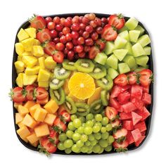 a platter filled with lots of different types of fruits and veggies on top of each other