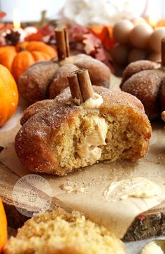 a muffin is cut in half and placed on a table next to other pumpkins