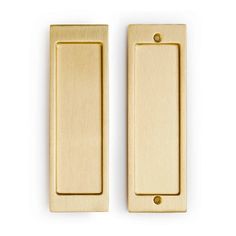 two brass door handles on a white background