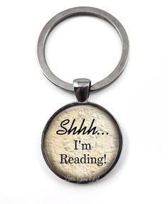 a keychain with the words shh i'm reading on it