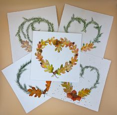 four cards with watercolor leaves arranged in the shape of a heart