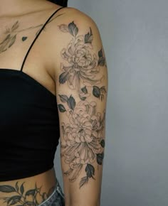 a woman's arm with flowers on it