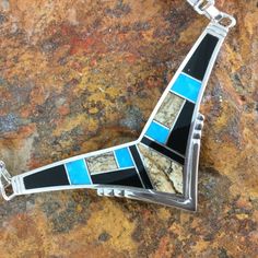 This gorgeous Sterling Silver Necklace shown in the Turquoise Creek Collection, features Black Jade, Picture Jasper, and Kingman Turquoise. Dimensions:1"T x 2 1/2"W w/ 14" Omega Chain They are designed by David Rosales, one of the finest contemporary Southwest Artists in the world. He is the founder and co-owner of Supersmiths, Inc. of Gallup, NM. This Handcrafted Necklace is custom made and carries a lifetime guarantee. In the event that this item is in stock in our Prescott store, we will ship it within 2 business days. Otherwise, Please allow 3-4 weeks for delivery. Note: Prices are subject to change with fluctuations in the price of silver. If you need a rush order or are interested in Yellow or White Gold please call 1.800.621.6668. Unique Blue Necklace With Inlay, Artisan Blue Inlay Necklaces, Unique Blue Turquoise Inlay Necklace, Turquoise Pendant Necklace With Inlay, Collectible Blue Inlay Necklace, Southwestern Blue Turquoise Inlay Necklace, Artisan Blue Turquoise Necklace With Inlay, Southwestern Blue Necklace With Inlay, Southwestern Blue Inlay Necklace