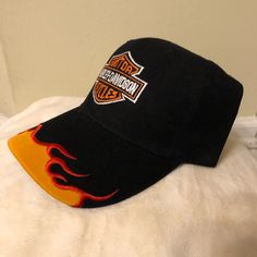 Vintage, Embroidered, 100% Cotton, With Velcro Adjustable Closure, One Size Fits All Box 18 Black Embroidered Visor Trucker Hat, Black Embroidered Cotton Trucker Hat, Casual Orange Hat With Embroidered Logo, Orange Adjustable Hat With Embroidered Logo, Adjustable Orange Hat With Embroidered Logo, Casual Orange Sports Hat, Casual Orange Baseball Cap With Flat Bill, Orange Flat Bill Baseball Cap, Casual Orange Flat Bill Baseball Cap