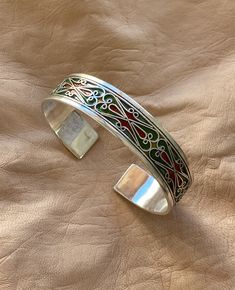 "This is a great silver and enamel cuff bracelet from Morocco. It measures just under 5/8\" (1,45 cm) at the widest and the inner diameter is just over 2 3/8\" (6,1 mm) wide. It is slightly adjustable as it is a cuff style bracelet. The bracelet features fantastic filigree-style wirework with unique-colored enamel." Moroccan Bracelet, Protection Amulet, Stacked Jewelry, African Jewelry, Big Earrings, Wire Work, Enamel Jewelry, Unique Colors, Fashion Bracelets