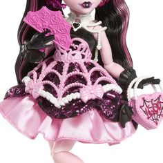 the doll is wearing a pink dress and holding a heart shaped object in her hand