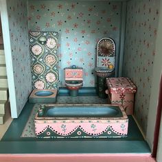 a dollhouse bathroom with pink and blue decor