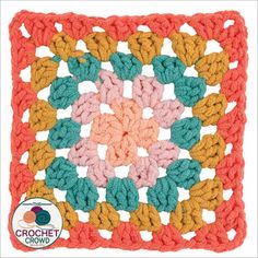 a crocheted square with an orange and pink center