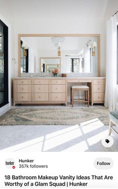 a bathroom with a large mirror, vanity and stool in the middle of the room