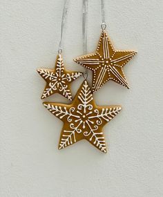 three star shaped ornaments hanging on a wall