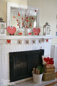 a fireplace decorated for valentine's day with paper hearts