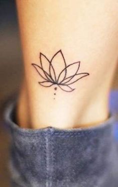 a small lotus tattoo on the ankle