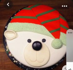 a decorated cake with a bear wearing a santa hat