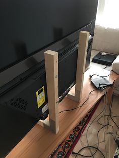 a flat screen tv sitting on top of a wooden table