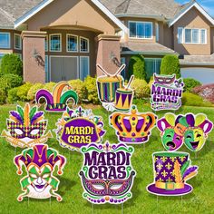 mardi gras yard decorations are in front of a house with grass and bushes