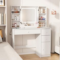 a white desk with drawers and a mirror on top of it in front of a bed