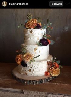 a three tiered cake with flowers and succulents on the top layer