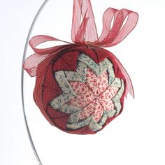 an ornament hanging from a glass stand