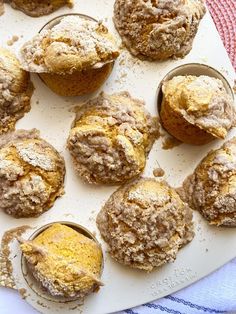 muffins with powdered sugar are on a plate