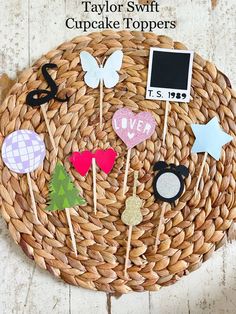 some cupcake toppers are on a wicker basket with other items in it