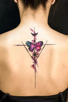 the back of a woman's neck with a butterfly tattoo on it