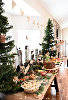 a buffet table is decorated with christmas trees and other holiday foods for the guests to eat