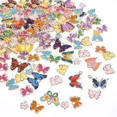 a pile of colorful butterflies sitting on top of a white table