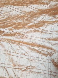 an orange and white bed spread with lines on it