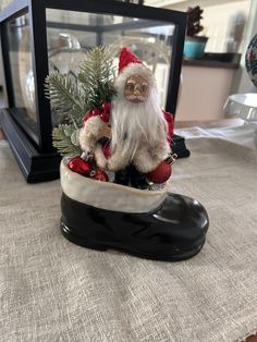 a santa clause figurine sitting on top of a table