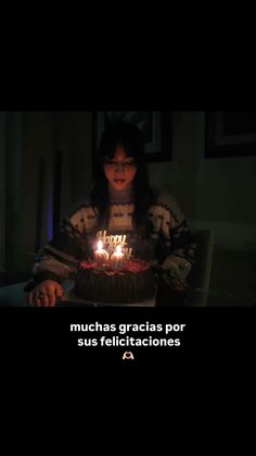 a woman sitting in front of a cake with lit candles on it and the caption reads, munchs gracias por su telectificticaciones