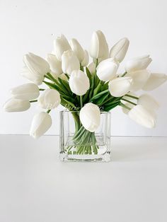 a vase filled with white flowers on top of a table