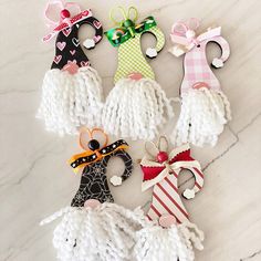 several knitted ornaments are arranged on a marble surface