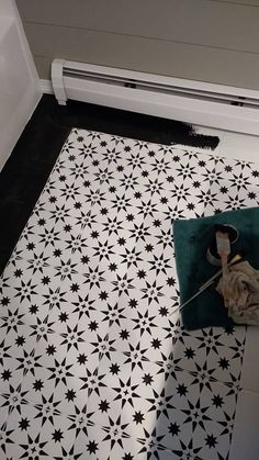 a black and white tiled floor with an air conditioner in the corner next to it