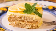 a slice of lemon cake on a plate with a fork