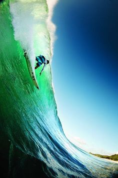 a man riding a wave on top of a surfboard