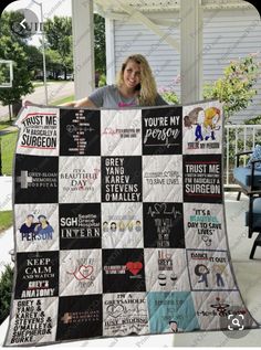 a woman is holding up a quilt with words on it